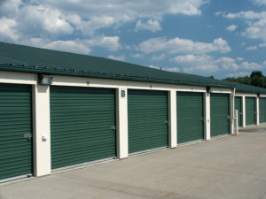a long row of storage units with a blue sky in the background